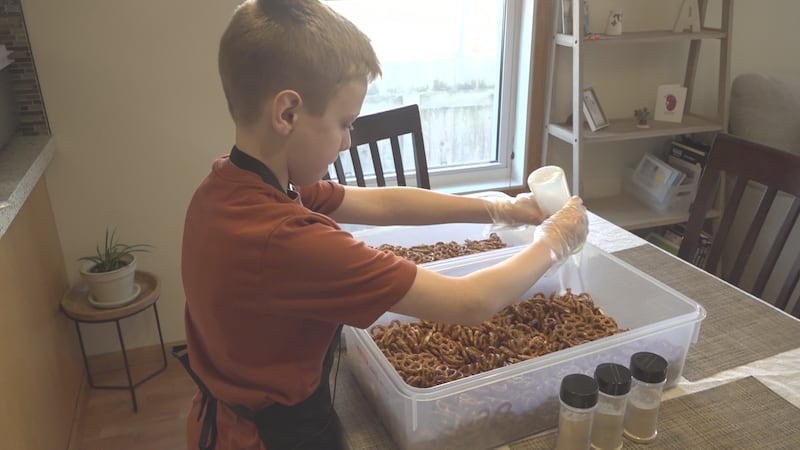 Connor Arbach, 12, making Twistology Seasoned Pretzels
