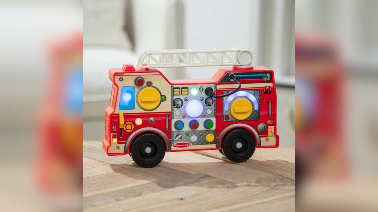FILE - Melissa and Doug Lights & Sounds Fire Truck Activity Board is a compact fire engine toy...