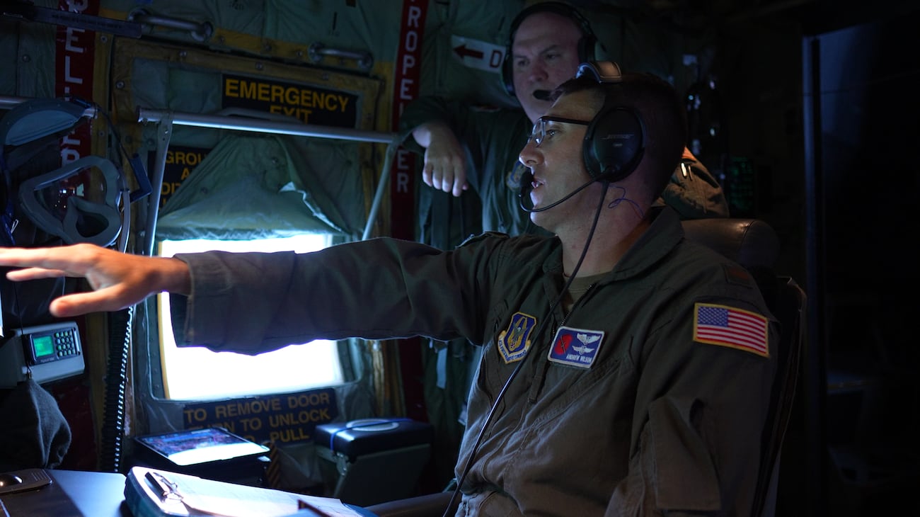Second Lt. Andrew Wilson discussing data with a Hurricane Hunters crew member.