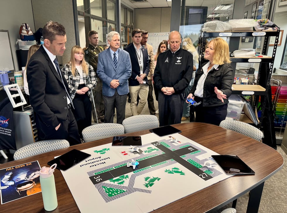 Sen. John Hoeven, center, watches a drone demonstration during a tour in Grand Forks on...