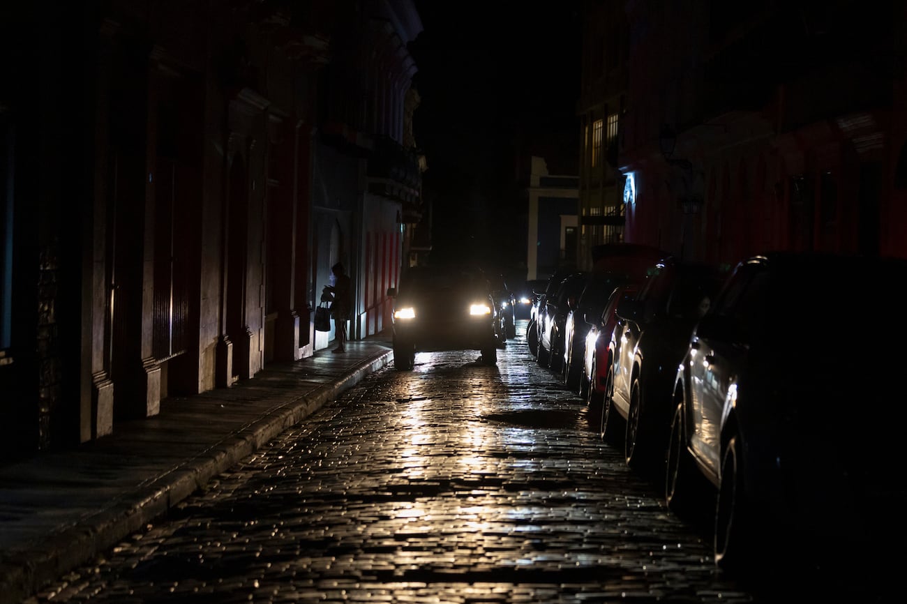 Headlights illuminate cobblestone streets in Old San Juan, Puerto Rico, during an island-wide...