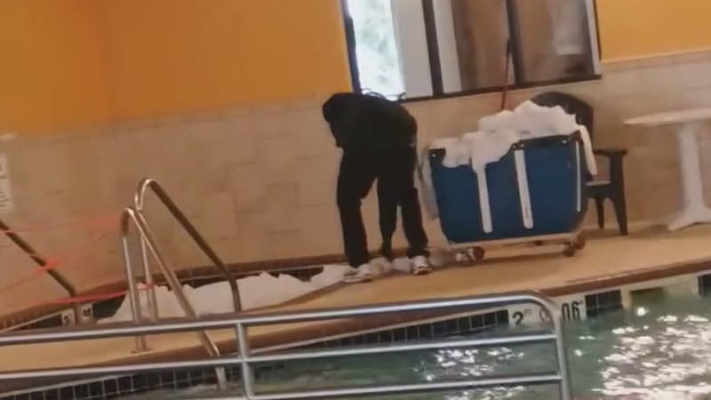 Expressway Suites employee soaking bed sheets in hot tub